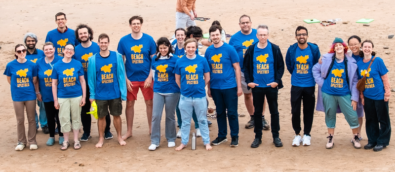 A line of people in blue Beach Spectres t-shirts, looking at the camera.