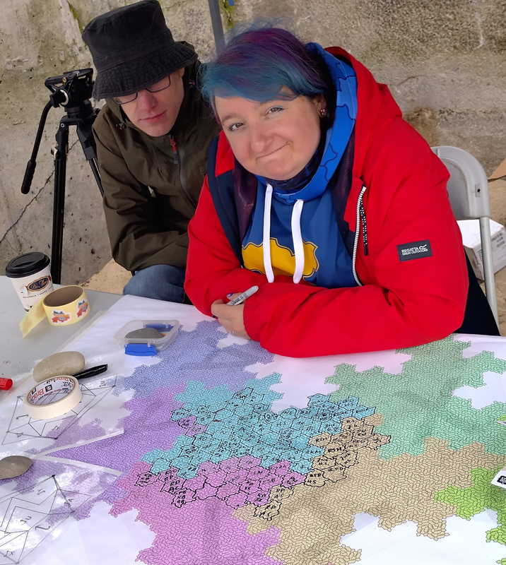 Katie Steckles and Paul Taylor sitting behind the map table.